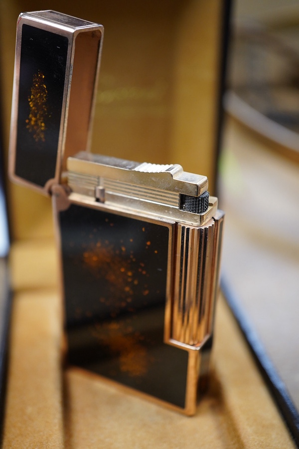 A cased Dupont 'gold dust' lighter with booklet. Condition - good